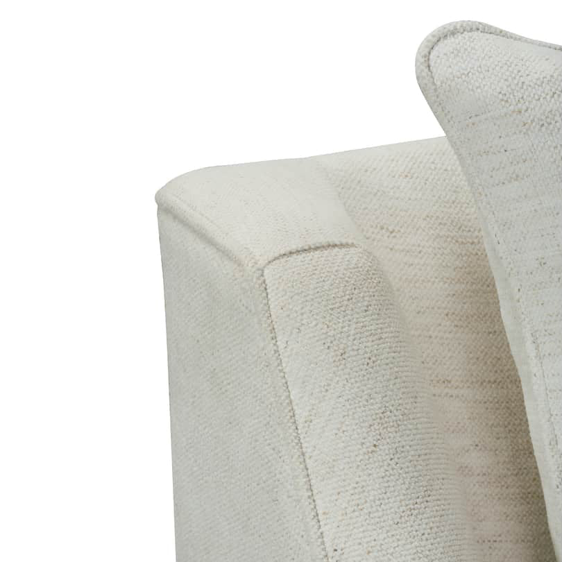 Close-up of a textured off-white fabric armrest and matching cushion on a white background.