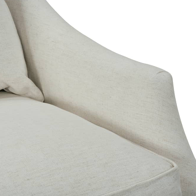 Close-up of a light beige upholstered armchair showing the seat cushion, back cushion, and curved arm against a plain white background.