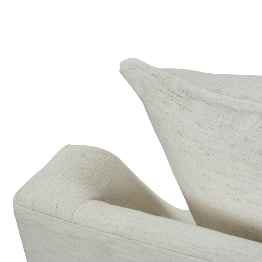 Close-up of a textured beige sofa on a white background