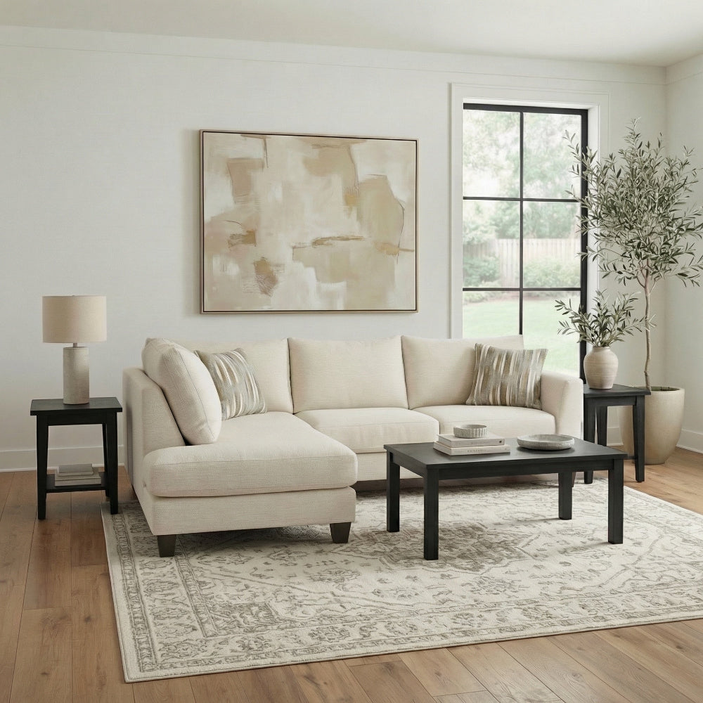 Living room with beige sectional sofa, coffee table, and abstract art on wall