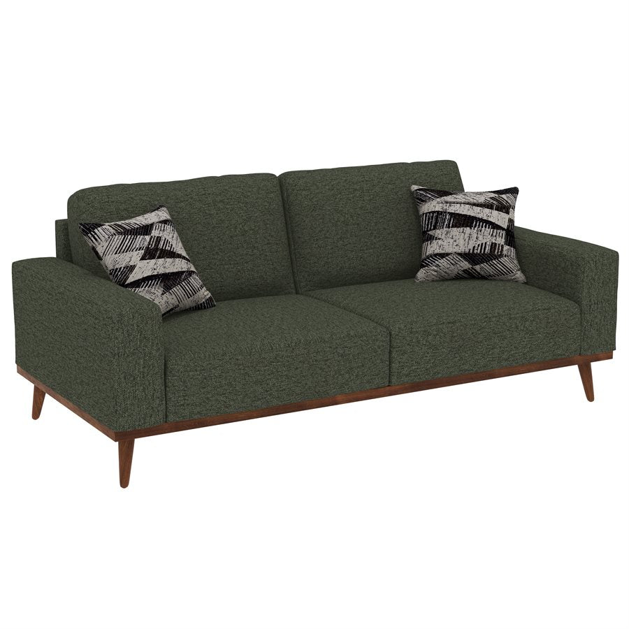 A dark green upholstered sofa with tapered legs and abstract print accent pillows, featuring a solid wood trim.