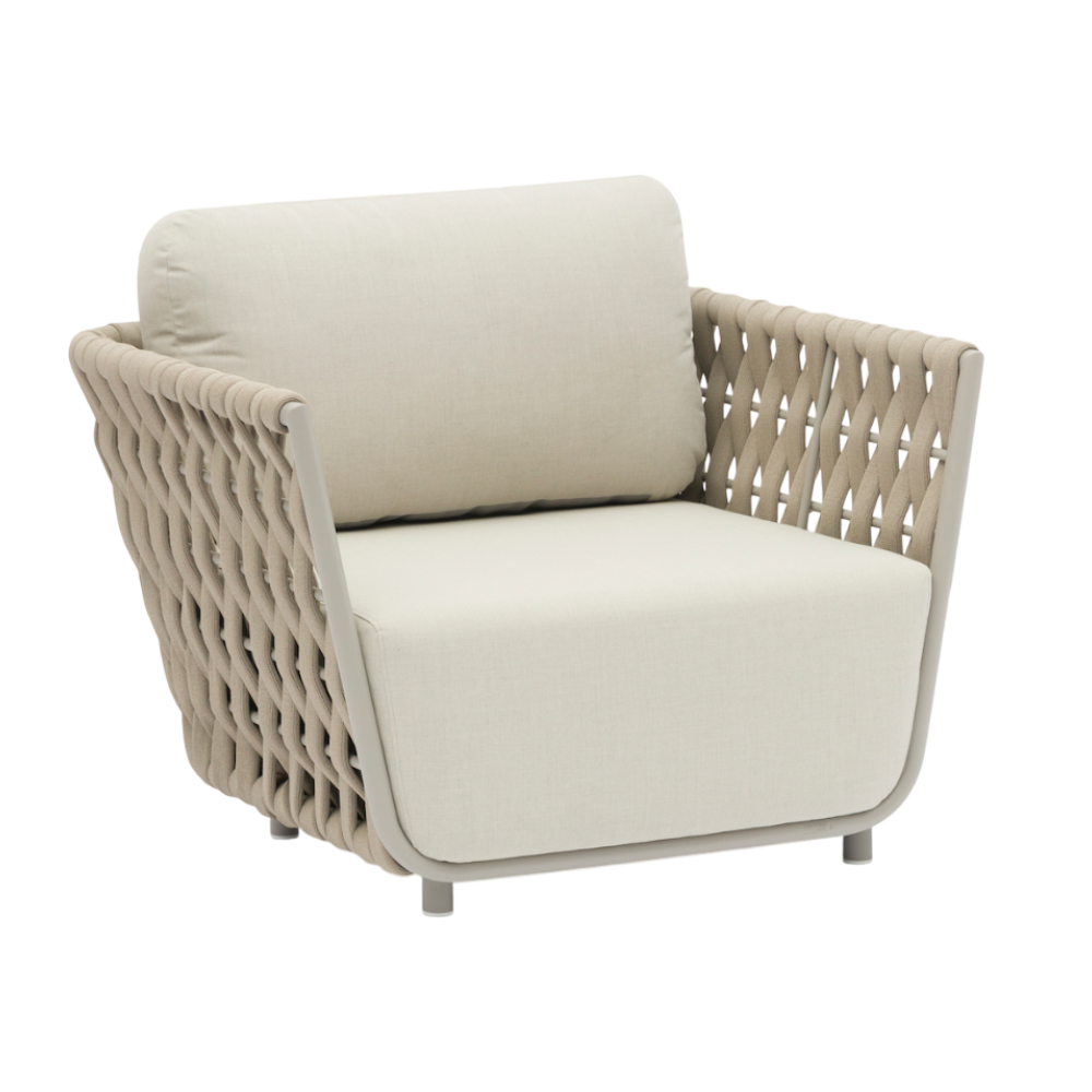 Beige wicker armchair with cream cushions on a white background